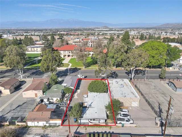 an aerial view of residential houses with outdoor space and ocean view