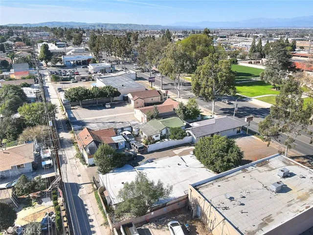 an aerial view of a house with a garden and lake view