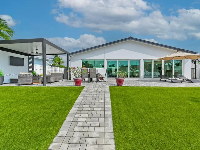 an aerial view of a house with pool patio and outdoor seating