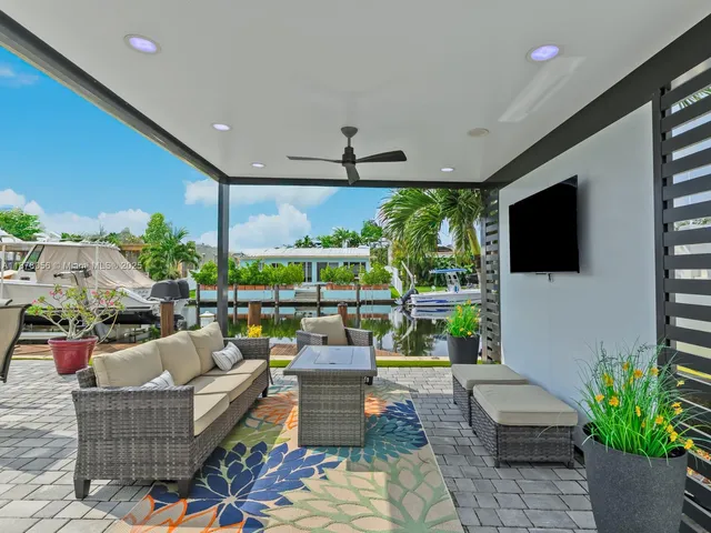 a view of a patio with a dining table and chairs