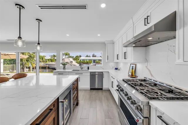 a living room with furniture a dining table and a chandelier