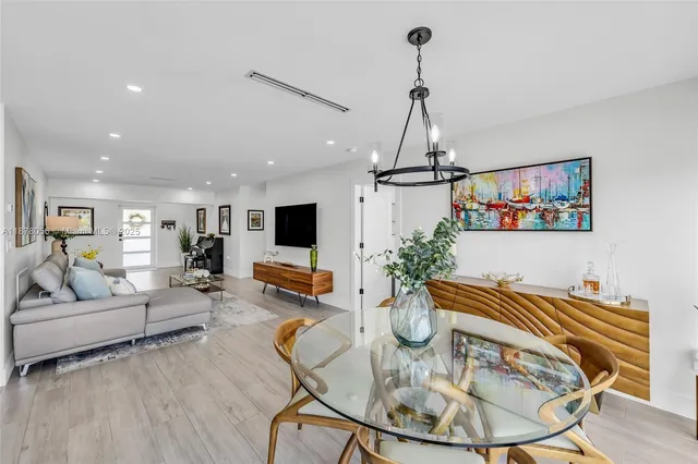 a view of a house with a swimming pool and sitting area