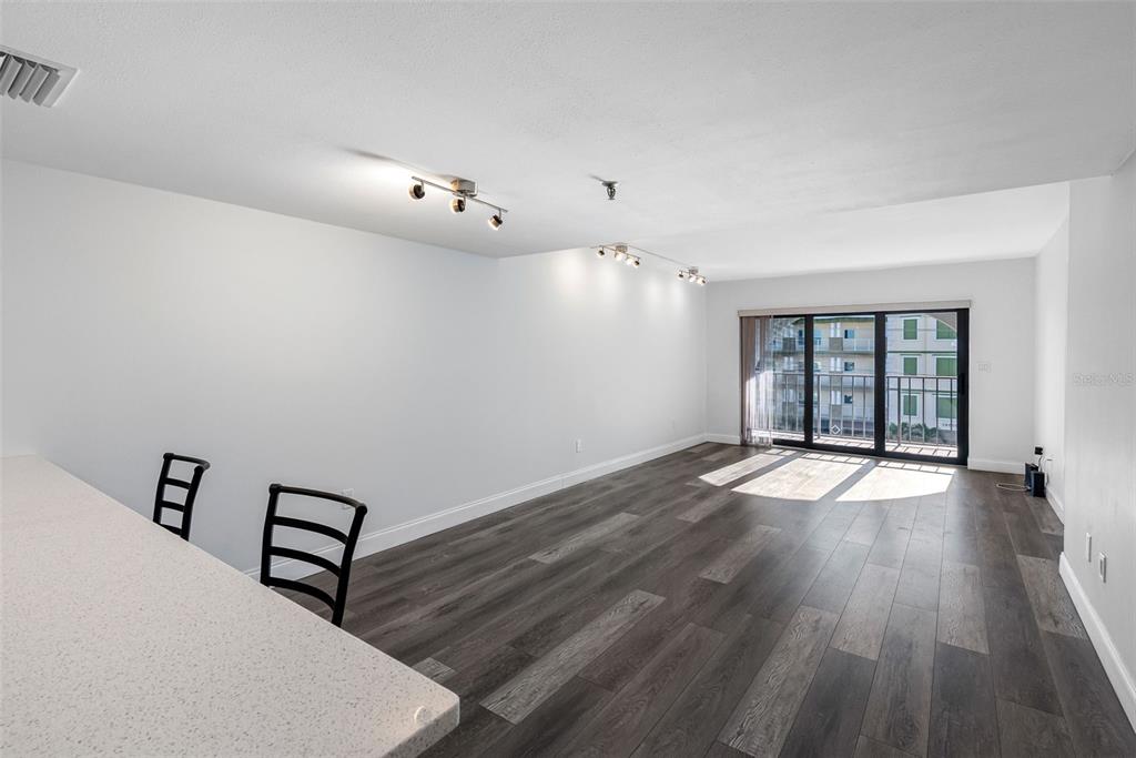 14001 Gulf Boulevard, Unit 404 Madeira Beach, FL 33708 - Photo 14 of 24 wooden floor in an empty room with a window