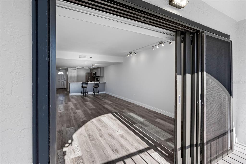 14001 Gulf Boulevard, Unit 404 Madeira Beach, FL 33708 - Photo 5 of 24 a view of a hallway with wooden floor and staircase