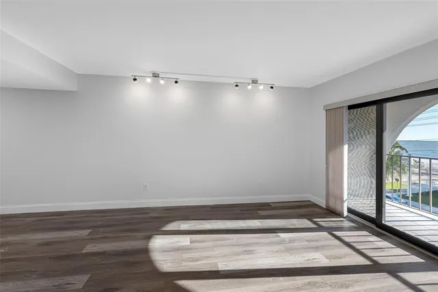 a view of an empty room and wooden floor