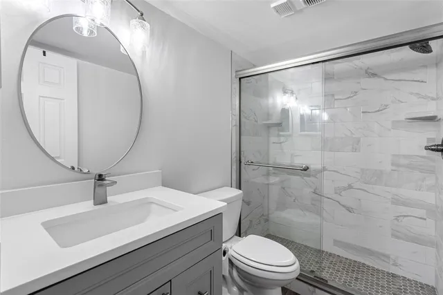 a kitchen with cabinets and stainless steel appliances