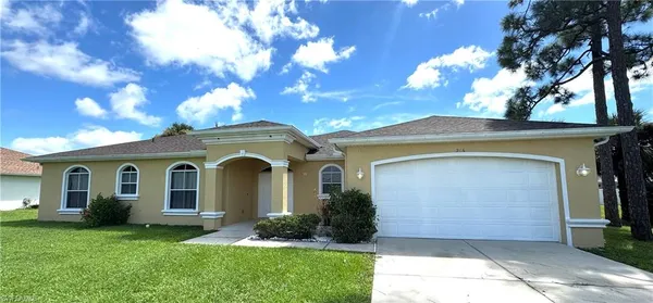 a front view of a house with a garden