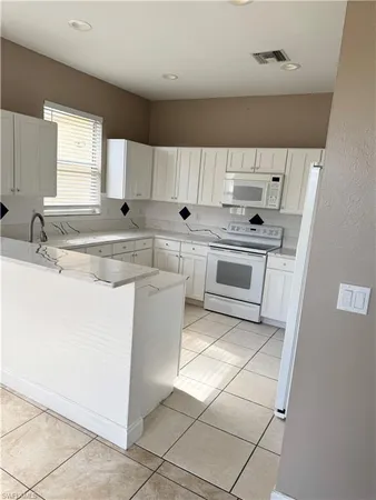 a view of kitchen with cabinets