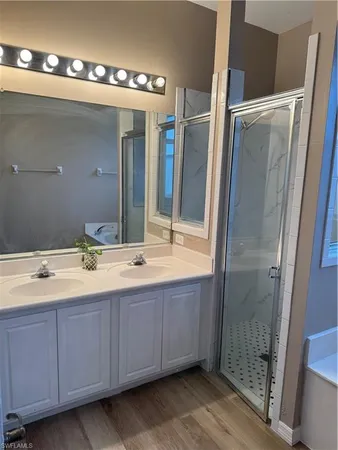 a white toilet sitting next to a sink and vanity