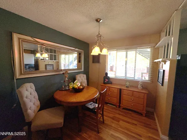 a dining room with furniture a chandelier and window