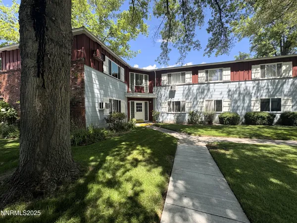a view of a house with a backyard