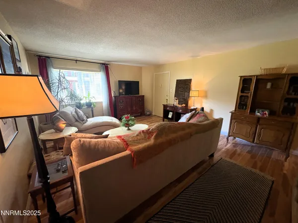 a bedroom with furniture and a flat screen tv