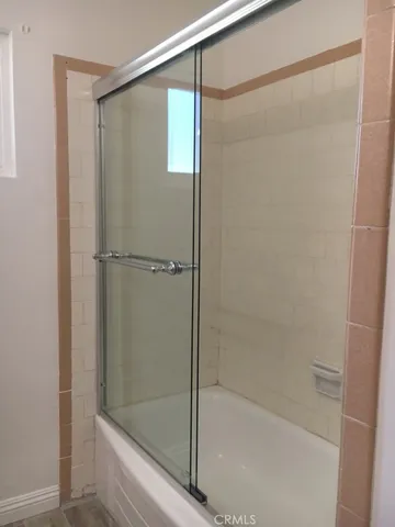 a bathroom with a glass shower door