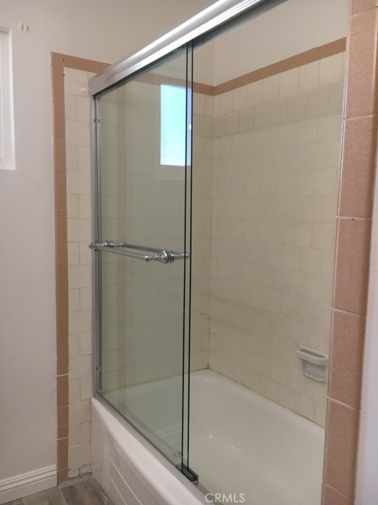 4031 MacArthur Road Riverside, CA 92503 - Photo 11 of 13 a bathroom with a glass shower door