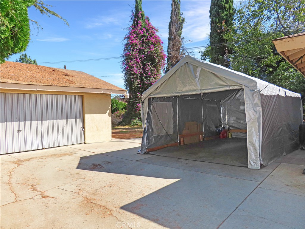 4031 MacArthur Road Riverside, CA 92503 - Photo 5 of 13 a view of a house with a yard and potted plants