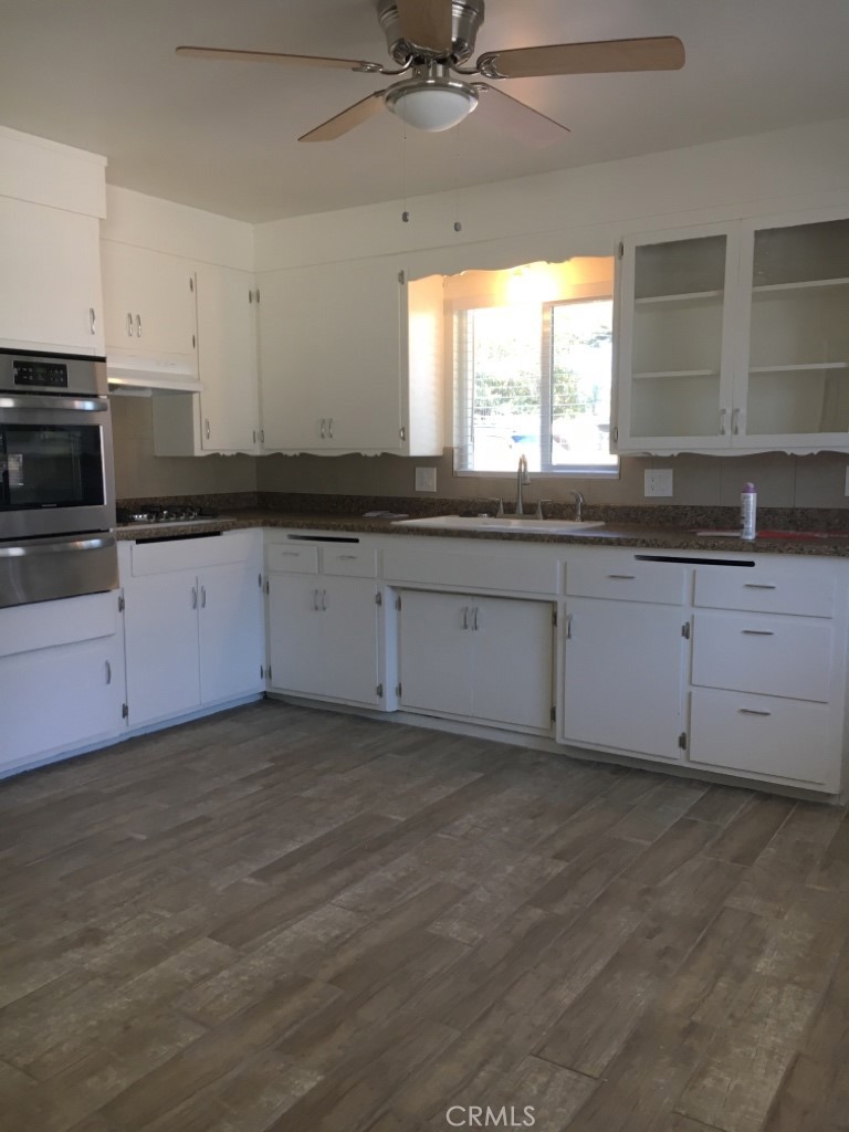 4031 MacArthur Road Riverside, CA 92503 - Photo 8 of 13 a kitchen with granite countertop a sink and a stove
