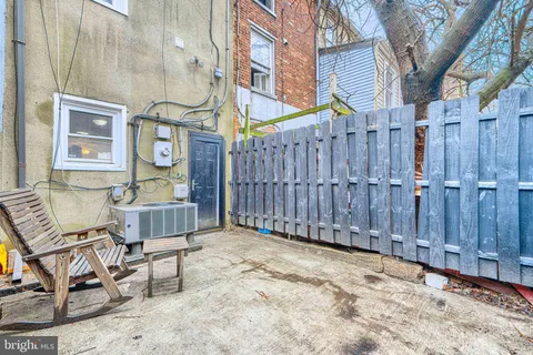 a view of a chairs with a house in the background