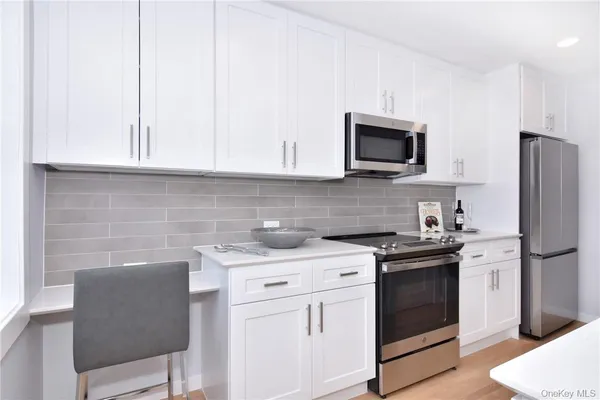 a kitchen with appliances a sink and cabinets