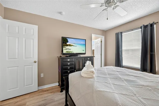 a bedroom with a bed and a chandelier