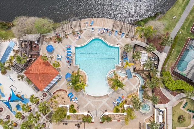 an aerial view of a house with swimming pool and outdoor seating