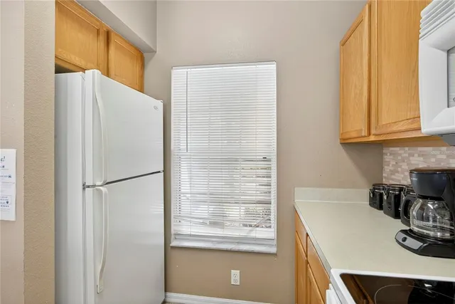 a white refrigerator freezer sitting inside of a kitchen