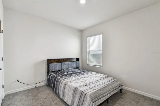 a bedroom with a bed and window