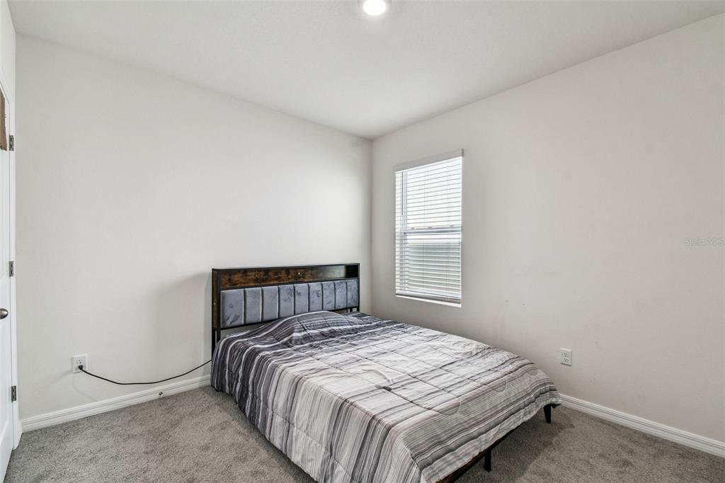 33635 Field Maple Loop Wesley Chapel, FL 33545 - Photo 13 of 35 a bedroom with a bed and window