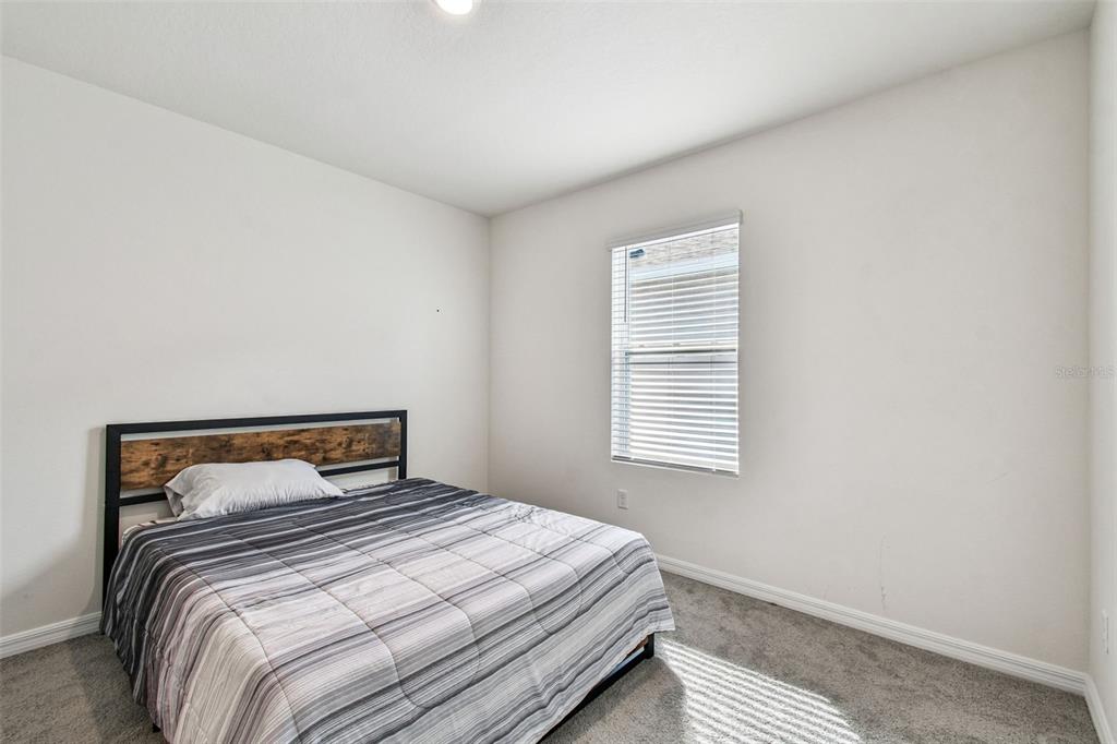 33635 Field Maple Loop Wesley Chapel, FL 33545 - Photo 16 of 35 a bedroom with a bed and window