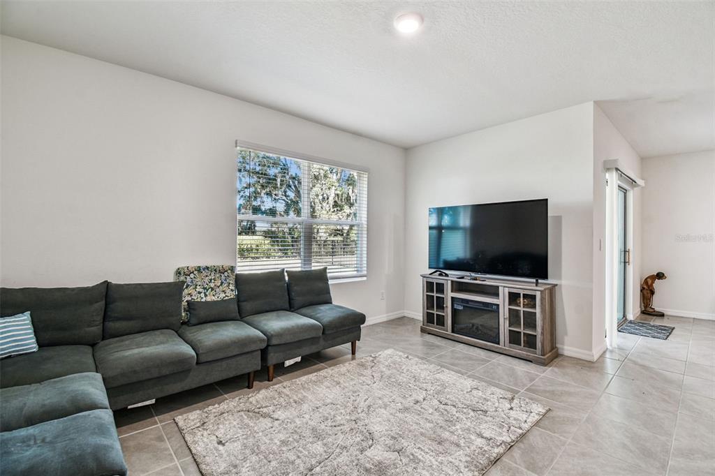 33635 Field Maple Loop Wesley Chapel, FL 33545 - Photo 20 of 35 a living room with furniture and a flat screen tv
