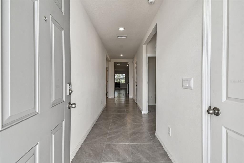 33635 Field Maple Loop Wesley Chapel, FL 33545 - Photo 2 of 35 a view of a hallway with wooden shelves