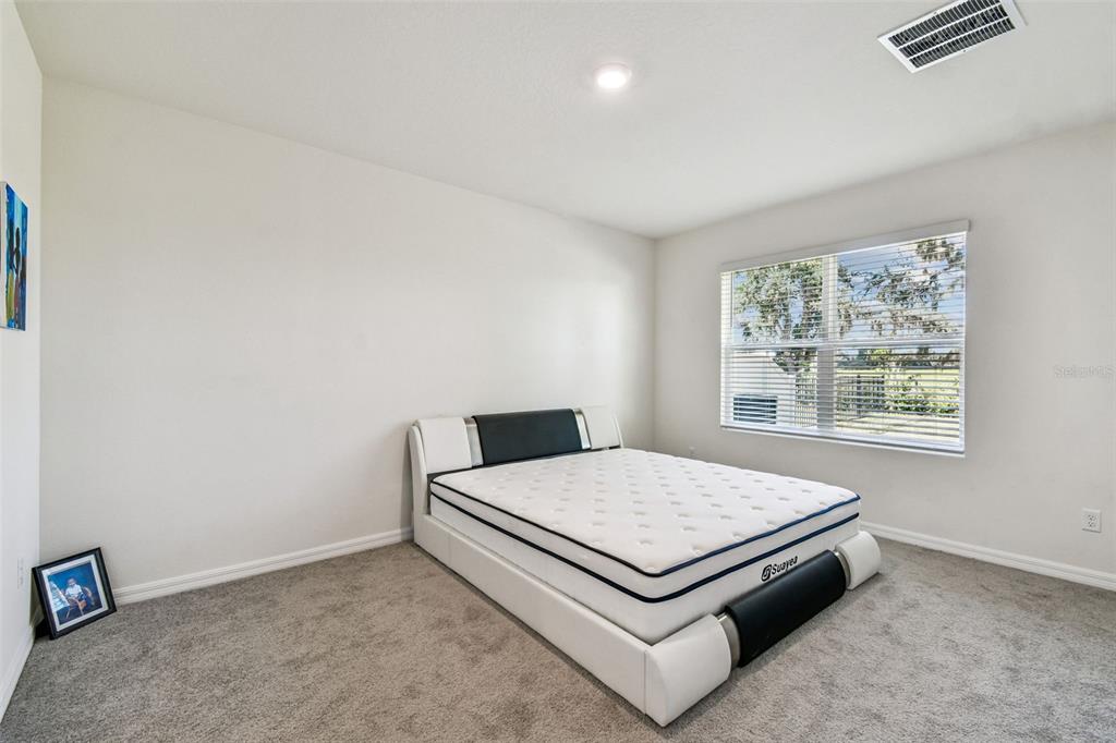 33635 Field Maple Loop Wesley Chapel, FL 33545 - Photo 23 of 35 a bedroom with a bed and window