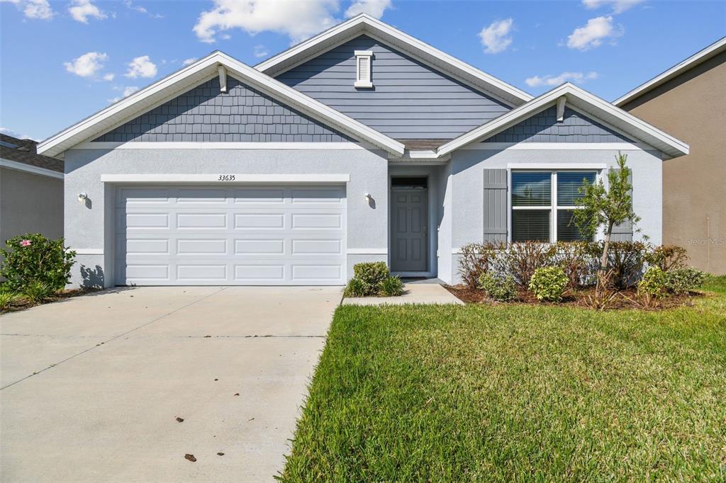 33635 Field Maple Loop Wesley Chapel, FL 33545 - Photo 35 of 35 a front view of a house with a yard