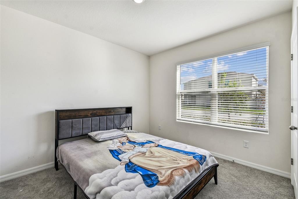 33635 Field Maple Loop Wesley Chapel, FL 33545 - Photo 6 of 35 a bedroom with a bed and a window