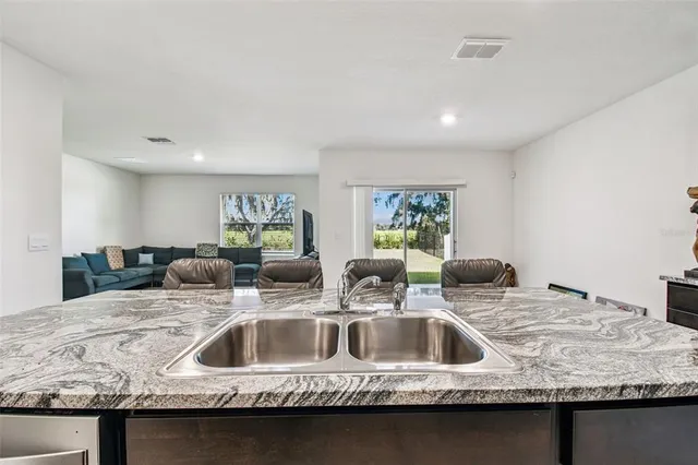 a kitchen with a sink and a refrigerator