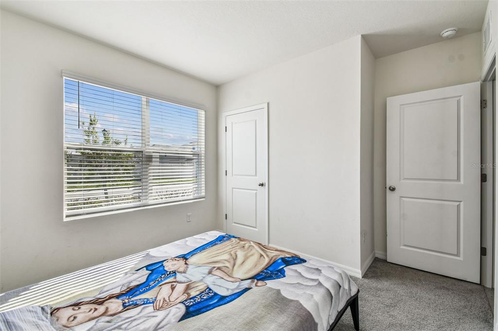 33635 Field Maple Loop Wesley Chapel, FL 33545 - Photo 10 of 35 a bedroom with a bed and a window