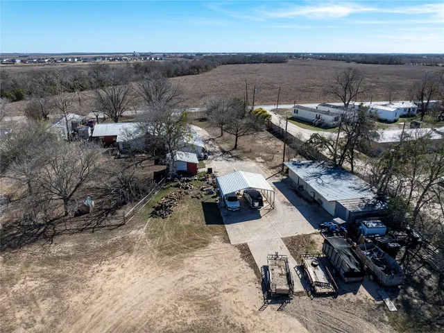 a view of a patio with a table and chairs under an umbrella