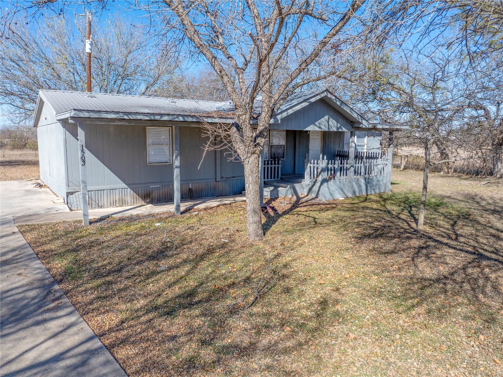 1403 Harris Hill Road San Marcos, TX 78666 - Photo 7 of 13 a view of a house with a yard