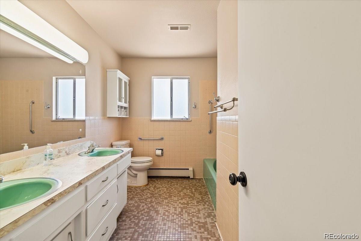 5 Rutgers Avenue Pueblo, CO 81005 - Photo 19 of 48 a bathroom with a double vanity sink toilet and shower