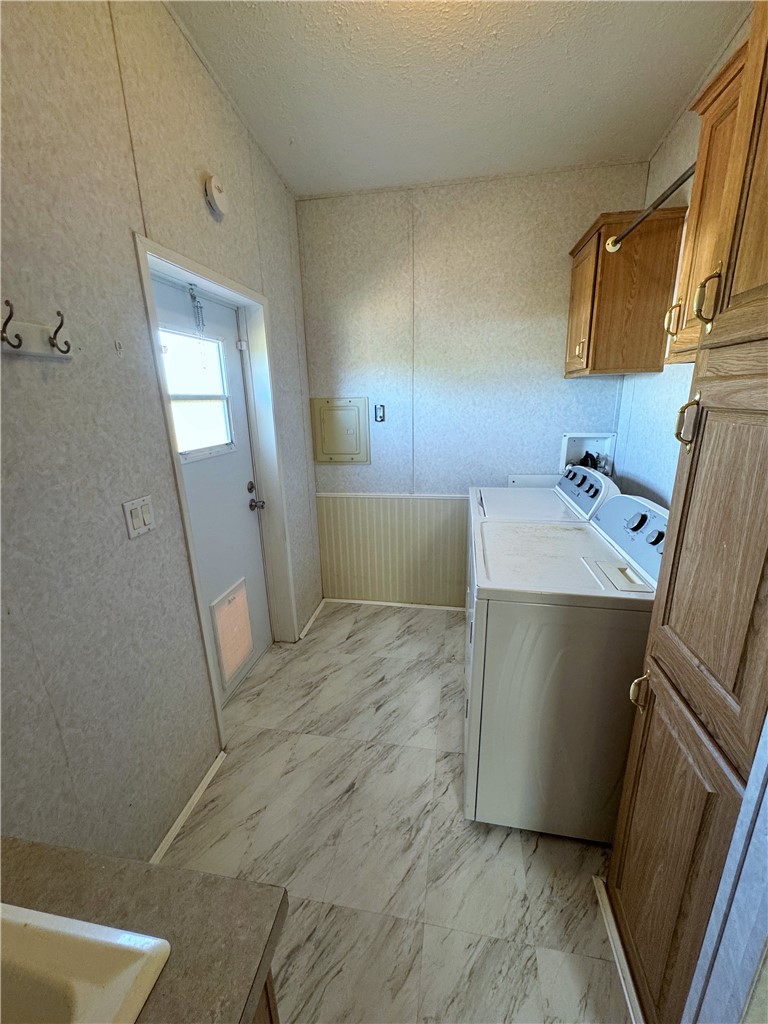 14224 East Randy Ranch Road Kingman, AZ 86401 - Photo 11 of 75 Utility area featuring light-toned flooring, a washing machine, and wood-toned cabinetry