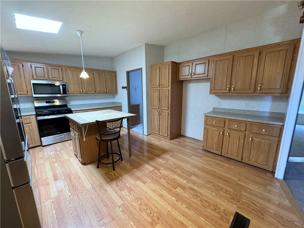 14224 East Randy Ranch Road Kingman, AZ 86401 - Photo 13 of 75 The kitchen features ample cabinetry, a ceiling-mounted light fixture, and a skylight providing natural illumination