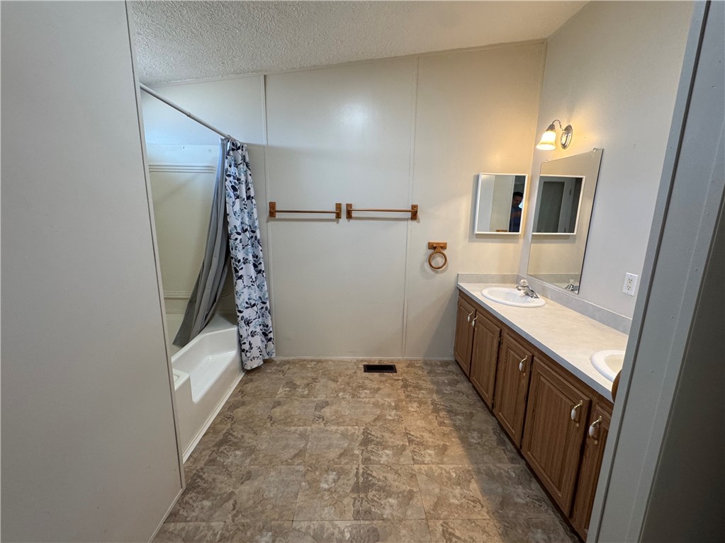 14224 East Randy Ranch Road Kingman, AZ 86401 - Photo 15 of 75 The bathroom features a double vanity with ample storage cabinets, two mirrors, and overhead lighting