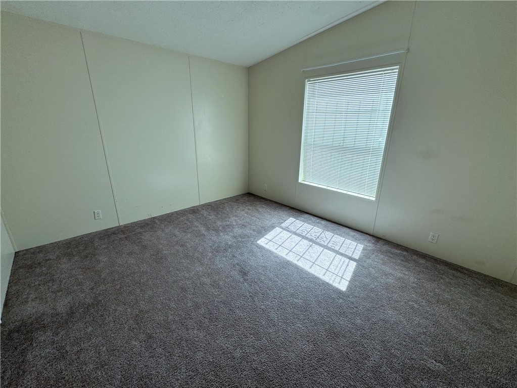 14224 East Randy Ranch Road Kingman, AZ 86401 - Photo 23 of 75 Room featuring neutral-toned walls, carpeted flooring, and a window with blinds