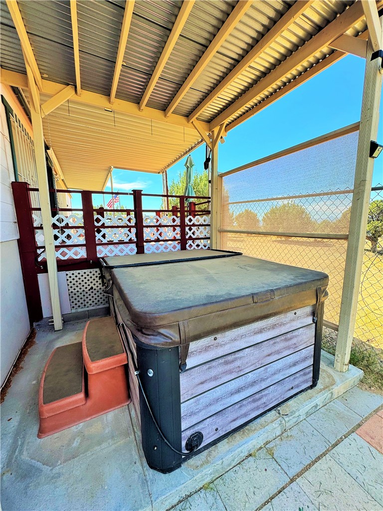 14224 East Randy Ranch Road Kingman, AZ 86401 - Photo 26 of 75 This property features a covered patio area with a hot tub, complete with access steps