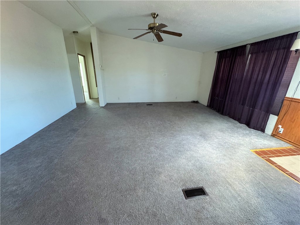 14224 East Randy Ranch Road Kingman, AZ 86401 - Photo 28 of 75 This expansive room features light-colored walls, gray carpeting, and a ceiling fan