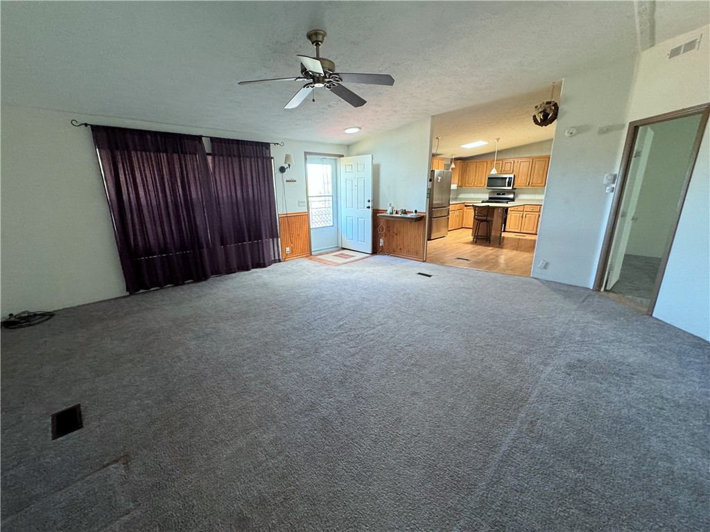 14224 East Randy Ranch Road Kingman, AZ 86401 - Photo 29 of 75 Spacious living area with carpet flooring and a ceiling fan