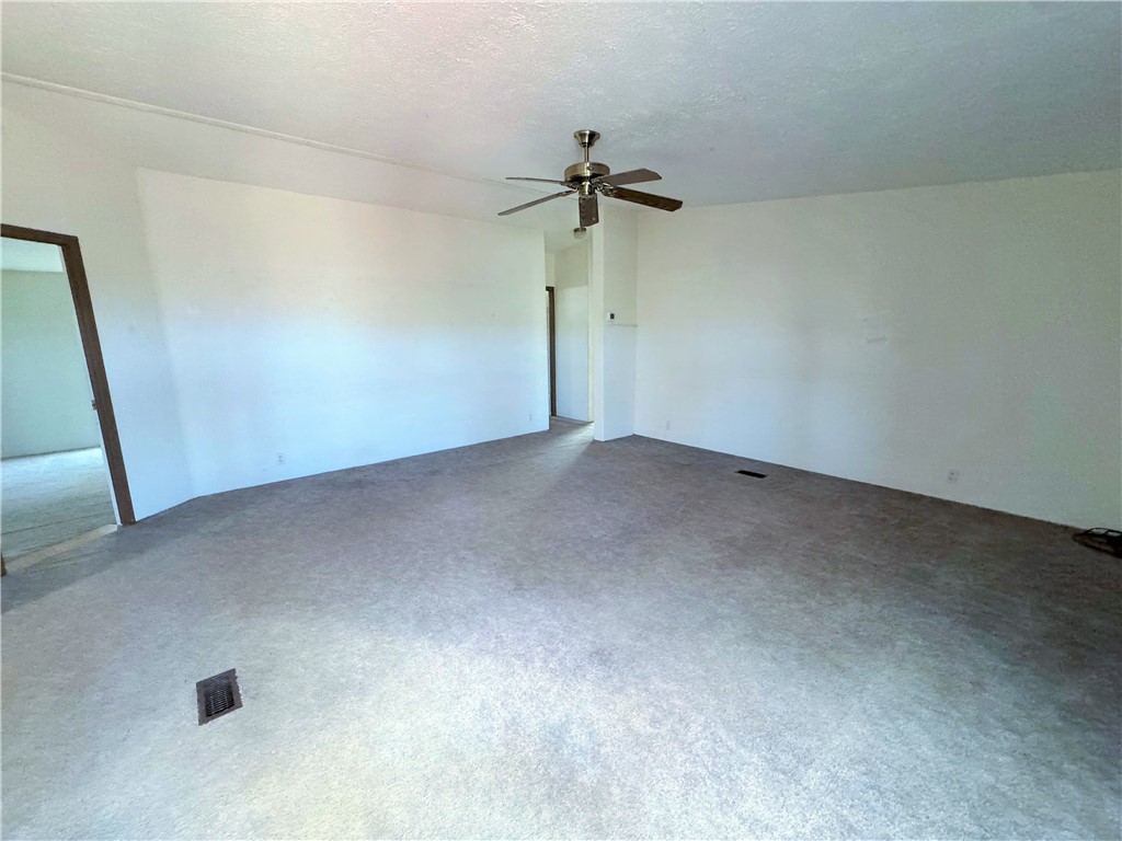 14224 East Randy Ranch Road Kingman, AZ 86401 - Photo 30 of 75 Spacious room with light-colored carpet and a ceiling fan