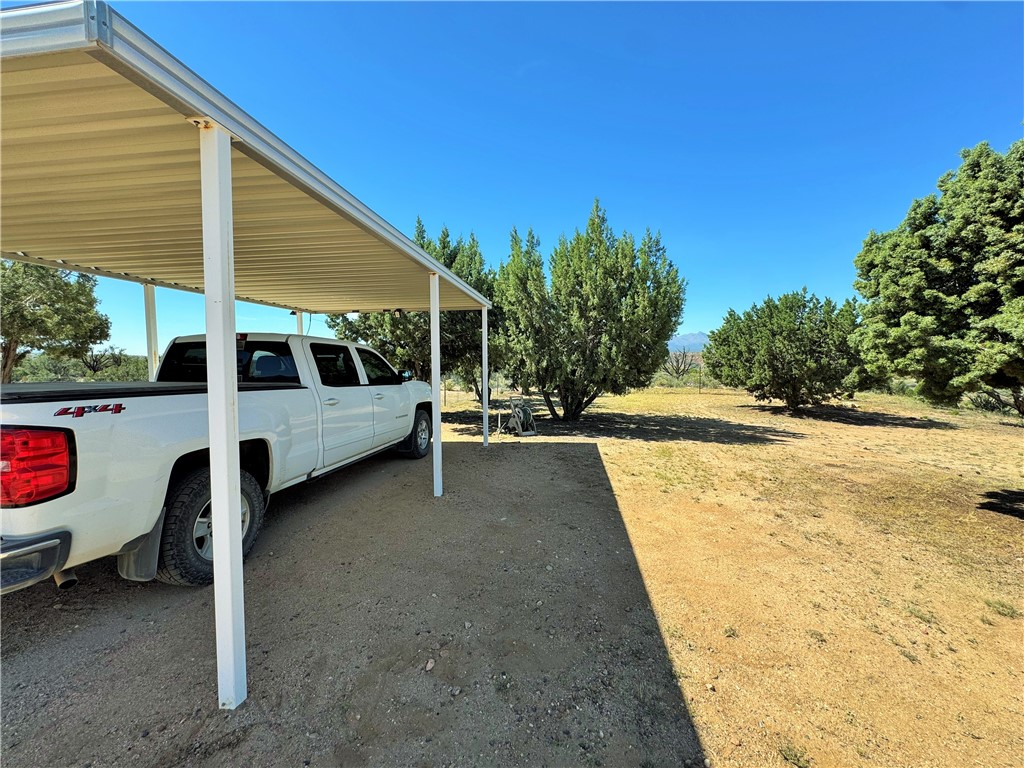 14224 East Randy Ranch Road Kingman, AZ 86401 - Photo 37 of 75 The property features an outdoor carport and a spacious yard with mature trees