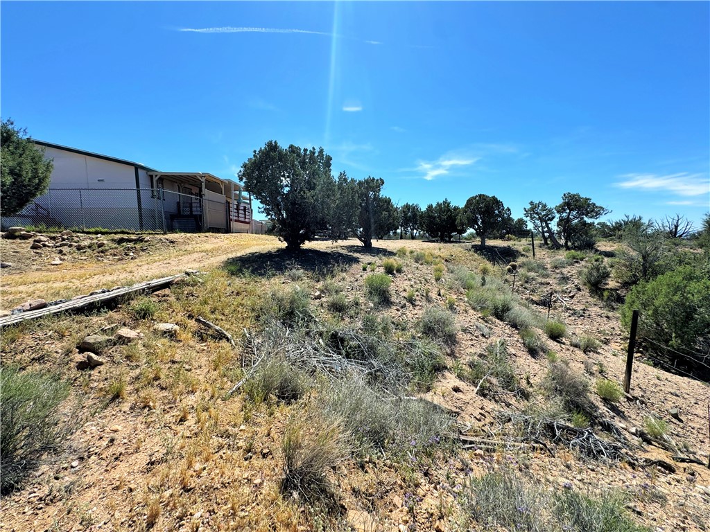 14224 East Randy Ranch Road Kingman, AZ 86401 - Photo 46 of 75 The property features a building with a light-colored exterior and a covered porch area