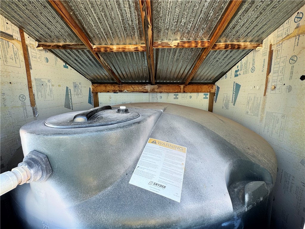 14224 East Randy Ranch Road Kingman, AZ 86401 - Photo 69 of 75 The property features a water storage tank, housed within a structure with corrugated metal roofing and wood supports