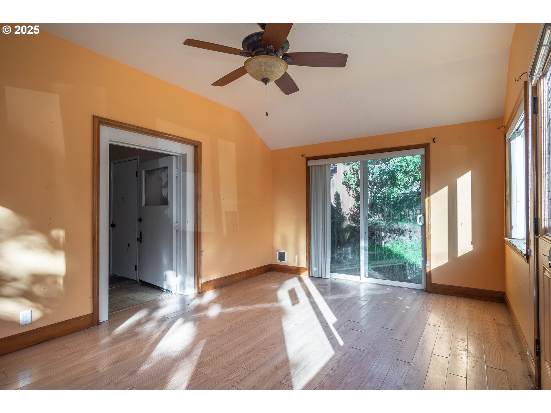 839 Union Gap Loop Oakland, OR 97462 - Photo 4 of 24 a view interior of a house with wooden floor a ceiling fan and windows